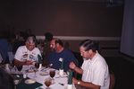 Dave Goodwin and Wes Biggs dine at a round banquet table during a Florida Ornithological Society meeting in Tallahassee, Florida by Florida Ornithological Society