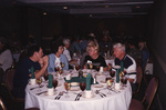A table of guests chat engagedly during a Florida Ornithological Society meeting in Tallahassee, Florida