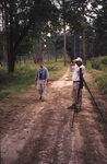 Two birders observe a patch of woods with binoculars during a trip in Tallahassee, Florida by Florida Ornithological Society