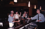 A group of Florida Ornithological Society members interact with a bartender in Tallahassee, Florida