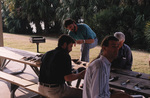 Florida Ornithological Society members take a bird skins quiz on an outdoor picnic bench during a meeting in Titusville, Florida