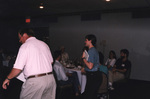 Two speakers gesture with papers in hand during a Florida Ornithological Society meeting in Titusville, Florida by Florida Ornithological Society