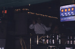 A man holds up both hands at a bar in Titusville, Florida by Florida Ornithological Society