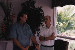 Dave Breininger speaks with Peter Merritt while holding a book in Titusville, Florida