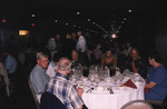 Guests chat in a large banquet room during a Florida Ornithological Society meeting in Titusville, Florida