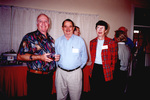 Ed Slaney smiles for a photo with two others in Fort Pierce, Florida