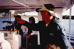A guest points at something during a boat tour in Fort Pierce, Florida by Florida Ornithological Society