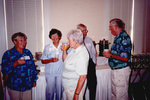 Soo Whiting, Maryanne Thomas, and Flip Harrington chat beside a refreshment table in Fort Pierce, Florida by Florida Ornithological Society