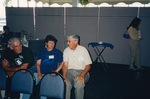 Three seated guests chat at a Florida Ornithological Society meeting in Fort Pierce, Florida