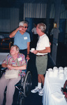 Hank Hull gestures beside wife Dotty while speaking with Bob Brown in Fort Pierce, Florida