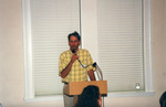 Jim Cox speaks into a microphone while wearing a yellow plaid shirt in Fort Pierce, Florida by Florida Ornithological Society