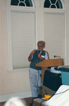A speaker holds up two fingers while presenting at a Florida Ornithological Society meeting in Fort Pierce, Florida