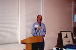 Peter Merritt speaks into a microphone at a Florida Ornithological Society meeting in Fort Pierce, Florida by Florida Ornithological Society