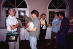 Fred Lohrer speaks with Eric Stolen while he cradles an infant in Fort Pierce, Florida by Florida Ornithological Society