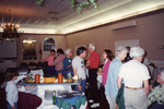 Guests mingle around a snack table at a Florida Ornithological Society meeting in Fort Pierce, Florida
