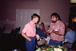 Pam Bowen speaks with Eugene Stoccardo next to a snack table in Fort Pierce, Florida by Florida Ornithological Society