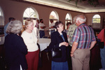 Guests mingle in an event hall at a Florida Ornithological Society meeting in Fort Pierce, Florida