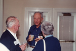 Three guests speak with drinks in hand at a Florida Ornithological Society meeting in Fort Pierce, Florida