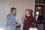 Two guests chat animatedly during a Florida Ornithological Society meeting in Fort Pierce, Florida