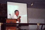 Sonny Bass gestures to a photo mid-presentation in Fort Pierce, Florida
