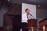 Dr. Paul Gray gestures mid-presentation in Fort Pierce, Florida
