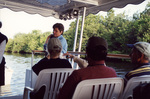 A guest cradles something against her shoulder during a boat tour in Fort Pierce, Florida