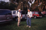 Two Birders with Binoculars Mingle by Row of Cars During Trip in Tallahassee by Florida Ornithological Society