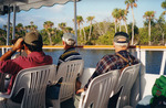 Three Tourists View Shoreline During Boat Tour in Fort Pierce by Florida Ornithological Society