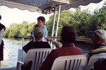 Guest Cradles Something Against Her Shoulder During Boat Tour in Fort Pierce by Florida Ornithological Society