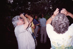 Marie Slaney Observes Something Overhead with Binoculars in Fort Myers by Florida Ornithological Society