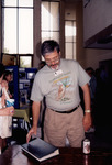 Dave Goodwin Consults Photo Album During Florida Ornithological Society Meeting in St. Petersburg by Florida Ornithological Society