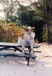 Fred Lohrer Peers Through Binoculars While Sitting Atop a Park Bench in St. Petersburg by Florida Ornithological Society