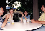 Todd Engstrom, Katy Nesmith, and Jim Cox Chat Animatedly on Outdoor Patio in St. Petersburg by Florida Ornithological Society