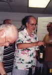 Fred Lohrer Passes Bottle of Wine at Florida Ornithological Society Meeting in Marathon, Florida by Florida Ornithological Society