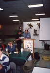 Dean Jue Consults Peter Merritt at Podium During Meeting in Clewiston by Florida Ornithological Society