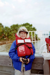 Joyce King Smiles in Life Jacket During Birding Trip in Apalachicola, Florida by Pamela J. Bowen