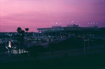 Parking garage and terminal at Tampa International Airport against a pink sky by Skip Gandy