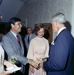 Rosalyn Carter watching two men shake hands by Skip Gandy