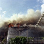Old Emilio Pons cigar factory in flames and bucket of fire truck by Skip Gandy