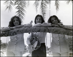 The three-sibling band The Fremis poses against a palm trees, B