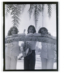 The three-sibling band The Fremis poses against a palm trees, C by Skip Gandy