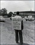 An Alfred S. Austin Construction Company employee strikes over the company's non-accordance with the local labor union in Tampa, Florida