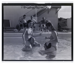 Four adults play games in an outdoor pool at Bay Pointe Condominiums in Tampa, Florida, A by Skip Gandy