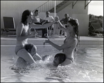 Four adults play games in an outdoor pool at Bay Pointe Condominiums in Tampa, Florida, C
