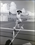 A tennis player gleefully leaps over the net at Bay Pointe Condominiums in Tampa, Florida, A by Skip Gandy