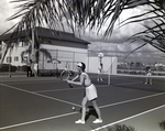 A single tennis player challenges a team of two during a game at Bay Pointe Condominiums in Tampa, Florida, B