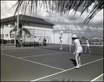 A single tennis player challenges a team of two during a game at Bay Pointe Condominiums in Tampa, Florida, D