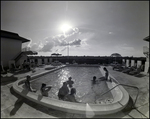 A group of friends mingle in the pool and on the deck at Bay Pointe Condominiums in Tampa, Florida, A