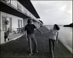 A couple holds hands by the water at Bay Pointe Condominiums in Tampa, Florida, B