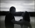 A couple embraces by the water at Bay Pointe Condominiums in Tampa, Florida, D